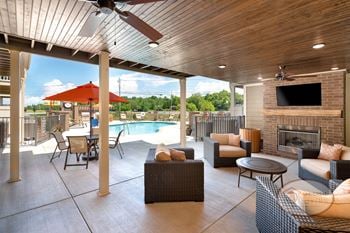 Outdoor pavilion with fireplace, flat screen tv, and food area